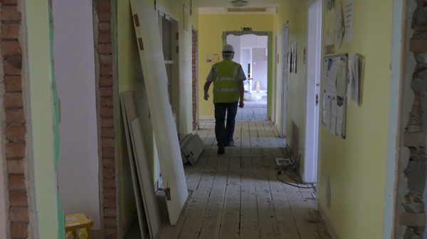View down a corridor of a building being renovated.
