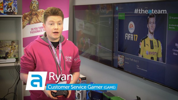 Gaming support staff member stands in front of screens.