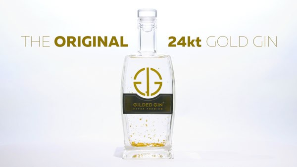 A bottle of gold flaked gin on a white background.