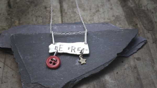 Hand made jewellery displayed on a broken piece of slate.