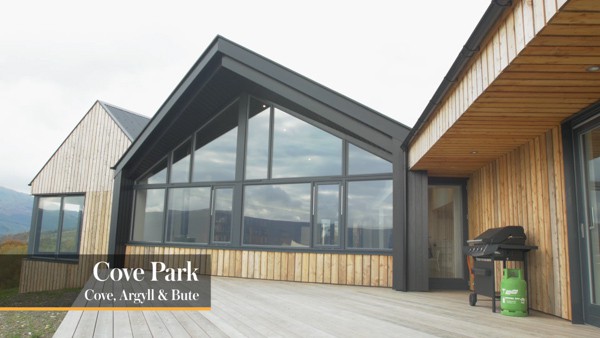 Cove Park, a glass and wood cladded building in the countryside.