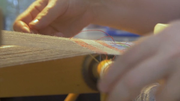 Creating textiles using s a manual loom.