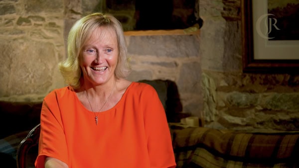 Woman laughing while being interviewed.